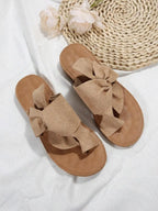 Elegant, comfortable, and versatile flat slippers; women's slip-on sandals with a bow detail; suede upper with a toe-separated design; casual fisherman-style beach sandals